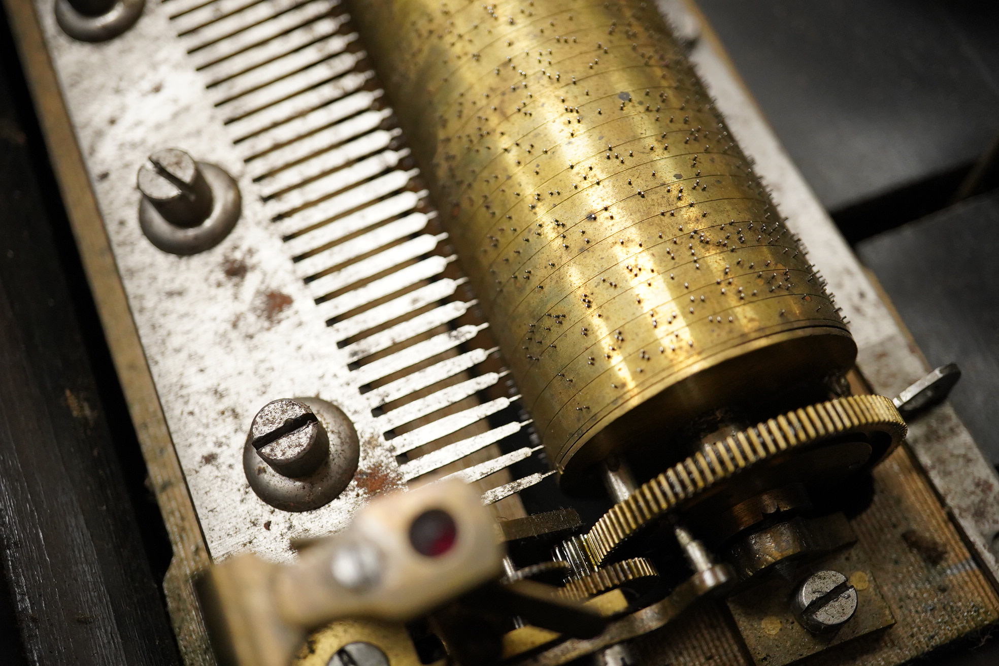 A mid-19th century inlaid and ebonised rosewood Swiss cylinder music box playing eight airs on a cylinder and three bells, card label to the inside of the lid listing the airs, complete with all teeth to the comb, cylind